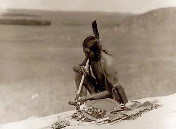 Indigenous Person Smoking a Peace Pipe
